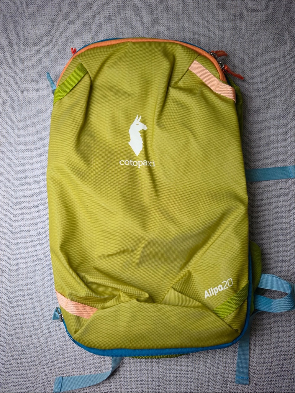 cotopaxi Allpa 20 L Olive green backpack with blue and peach accents